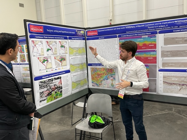 Juan Pablo Ramos explains his IMAGE 2023 poster on the crustal structure and hydrocarbon potential of the deepwater Colombian basin to student poster session judges.
